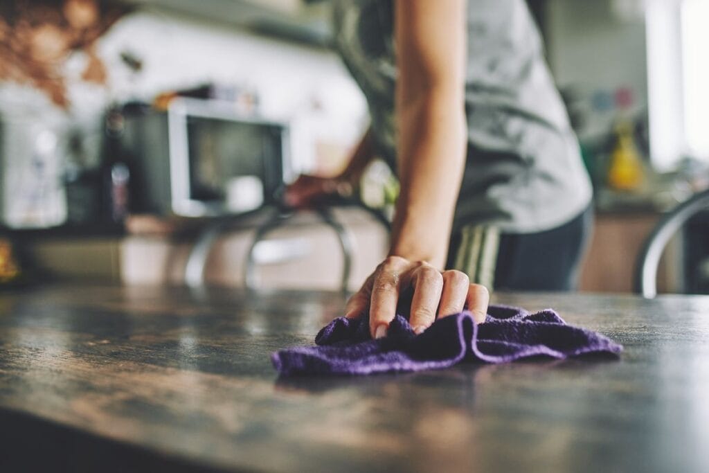 Professional residential cleaning services team cleaning a bright family living room