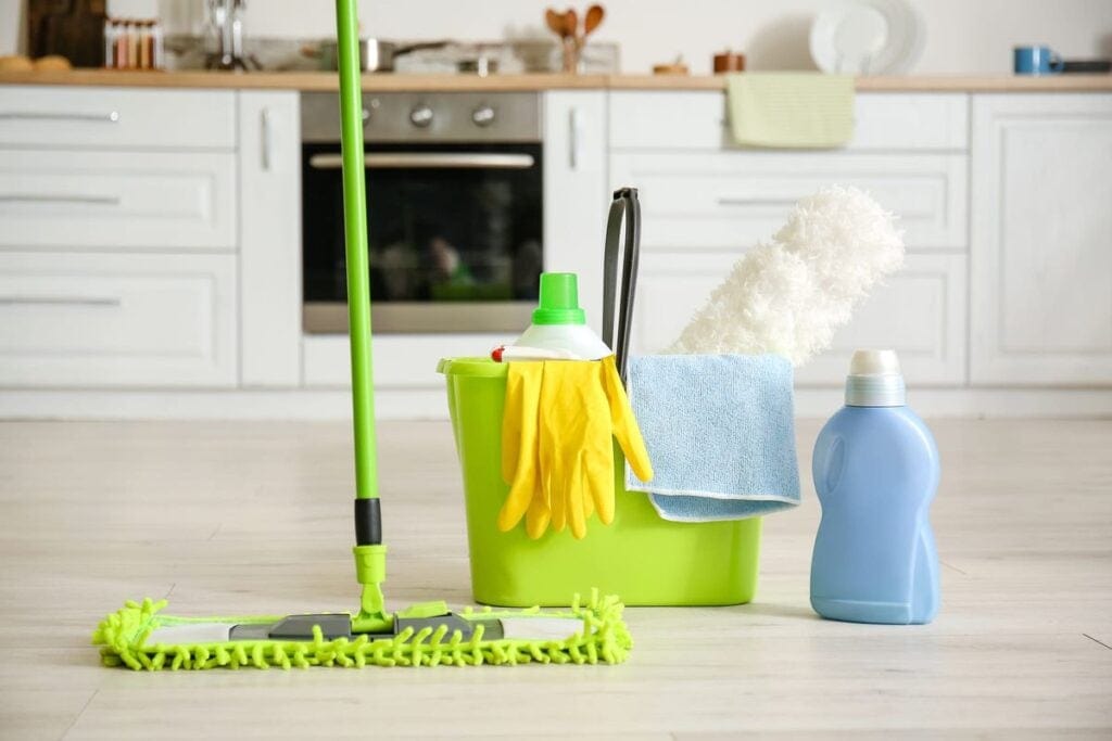 Professional residential cleaners performing a deep clean on a kitchen in Arlington Heights, IL.